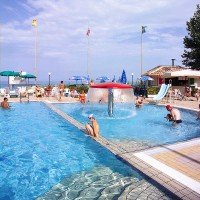 Swimming pool with cervical waterfalls and whirlpools