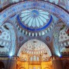 The dome of the Blue Mosque dominates the interior with its grandeur and harmony, decorated with floral motifs and Quranic calligraphy, and is the symbol of classical Ottoman architecture.