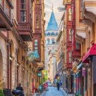 A typical cobblestone street leading to the Galata Tower (Galata Kulesi in Turkish), an iconic stone structure from the medieval era built by the genoese, located in the Galata district of Istanbul.
