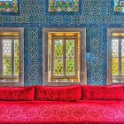 Blue and white Iznik tiles in Topkapi Palace, Istanbul, with floral patterns and arabesques showcasing the elegance of Ottoman art.