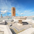 Spraying fountains and a large pool adorn the base of the Hassan Tower in Rabat, a historic emblem of 12th-century Islamic architecture.
