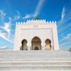 The Mausoleum of Mohammed V in Rabat, with its green dome and white stairs, is a masterpiece of 20th-century Arab-Andalusian architecture.