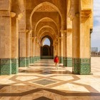 The arches of the Hassan II Mosque’s portico display refined details with hand-carved geometric and floral patterns, symbolizing Moroccan tradition and craftsmanship.