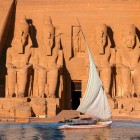 The spectacular scenery of the façade of the Abu Simbel Temple seen from a sailing boat cruising on Lake Nasser.