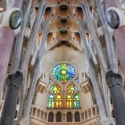 The nave of the Sagrada Família draws the eye towards the apse, where branching columns, geometric vaults and colourful stained-glass windows compose Gaudí’s forest-like basilica.