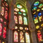 Inside the Sagrada Família, stained-glass windows illuminate the stone in red, green and blue, transforming the tree-inspired columns into Gaudí’s sacred forest of light.