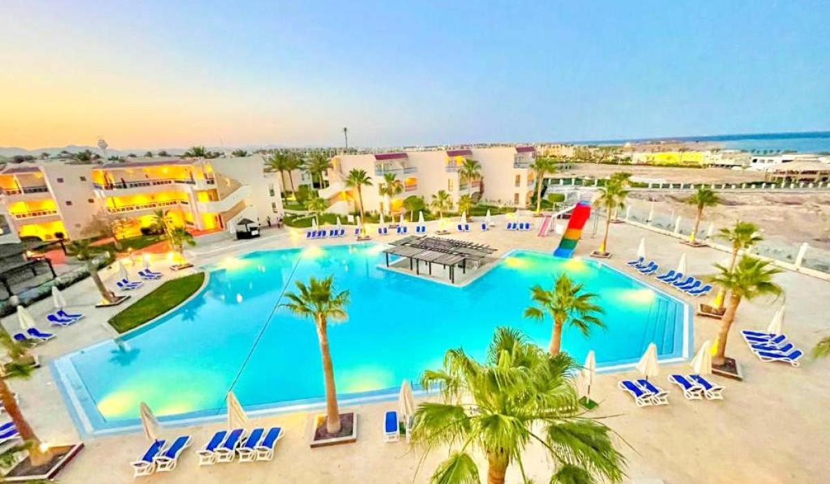 Ivy Cyrene Island Aqua Park Resort - Aerial view of the main pool and the resort’s three buildings, highlighting the pool bar at the center of the pool.