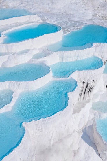 White travertine terraces at Pamukkale with natural pools rich in healing minerals, a unique and historic landscape.