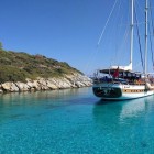 Gulet anchored in the stunning crystal-clear waters of Pabuc Bay, in the Aegean Sea, about 10 km from Bodrum, in Muğla Province, Turkey.
