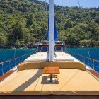 Exclusive Travellero gulet, bow area with a dedicated sun deck equipped with cushions, mattresses, and a courtesy table