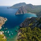 The shores of Kissebükü Koyu in Turkey are characterized by peaceful beaches, crystal-clear waters, and an unspoiled natural landscape, ideal for relaxation and tranquility.