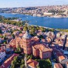 An aerial view of the Banat neighborhood, located in the Golden Horn in Istanbul, with the majestic Orthodox Church of St. George in the foreground. An image that captures the historical and cultural essence of the area.
