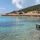Karaada Island, the largest in the area, is just 6 km from Bodrum and is famous for its healing mineral springs, ideal for wellness and relaxation.
