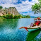 The traditional wooden boats of the Dalyan River glide slowly through the lush vegetation, offering breathtaking views of the rock-carved tombs and stunning glimpses of the local wildlife.
