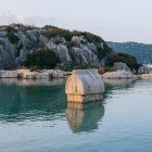 The sarcophagus of Simena, now Kaleköy, rises from the crystal-clear waters of the Mediterranean, surrounded by steep hills. A precious archaeological treasure of Lycia.