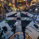 The Ginza Intersection is an iconic spot in Tokyo, famous for its neon lights, luxury shops, and frantic energy, symbolizing the city's modernity and vitality.