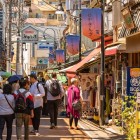 Yanaka Ginza, a historic street in Tokyo with traditional shops, local street food, a retro atmosphere, and the neighborhood mascot: the cat Sen, beloved by visitors and locals.