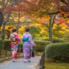 Girls in traditional clothing strolling through the paths of Kenroku-en Park in Kanazawa, Ishikawa Prefecture, considered one of Japan’s three most beautiful gardens.
