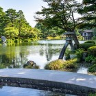 The magnificent Kenroku-en garden in Kanazawa reveals all its charm when seen from Kasumigaike Pond, where the iconic Kotoji-tōrō lantern stands out as a timeless symbol of Japan.