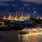 Chao Phraya River cruise on the "Wonderful Pearl" boat, with the Grand Palace, the Emerald Buddha Temple, and the Chakri Maha Prasat Throne Hall in the night backdrop.