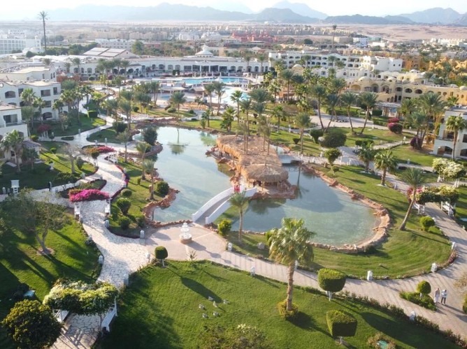 Royal Regency Club - Ultra All Inclusive - Drone aerial view of the Royal Regency Club showcasing the wide, well-kept walkways, crystal-clear pools, lush, well-maintained gardens, and the elegant resort structure.