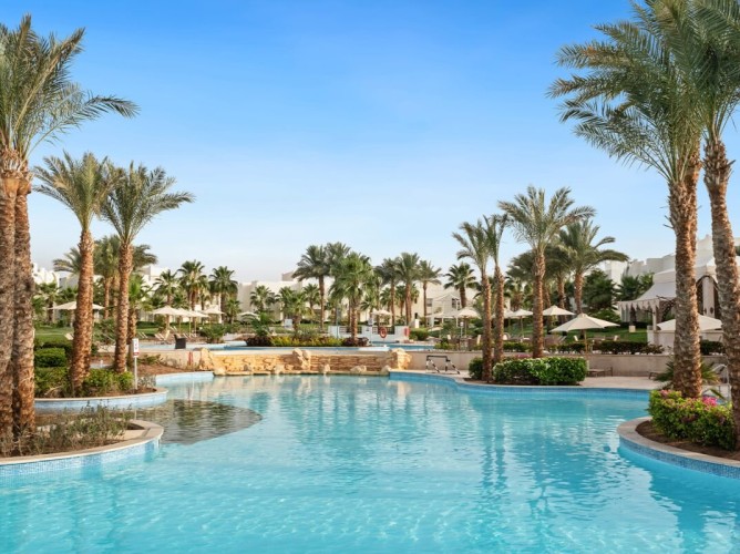 Swissôtel Sharm El Sheikh All Inclusive Collection - The pool area at Swissôtel Sharm El Sheikh All Inclusive Collection offers a wide variety of pools with varying depths, set amidst lush tropical gardens.
