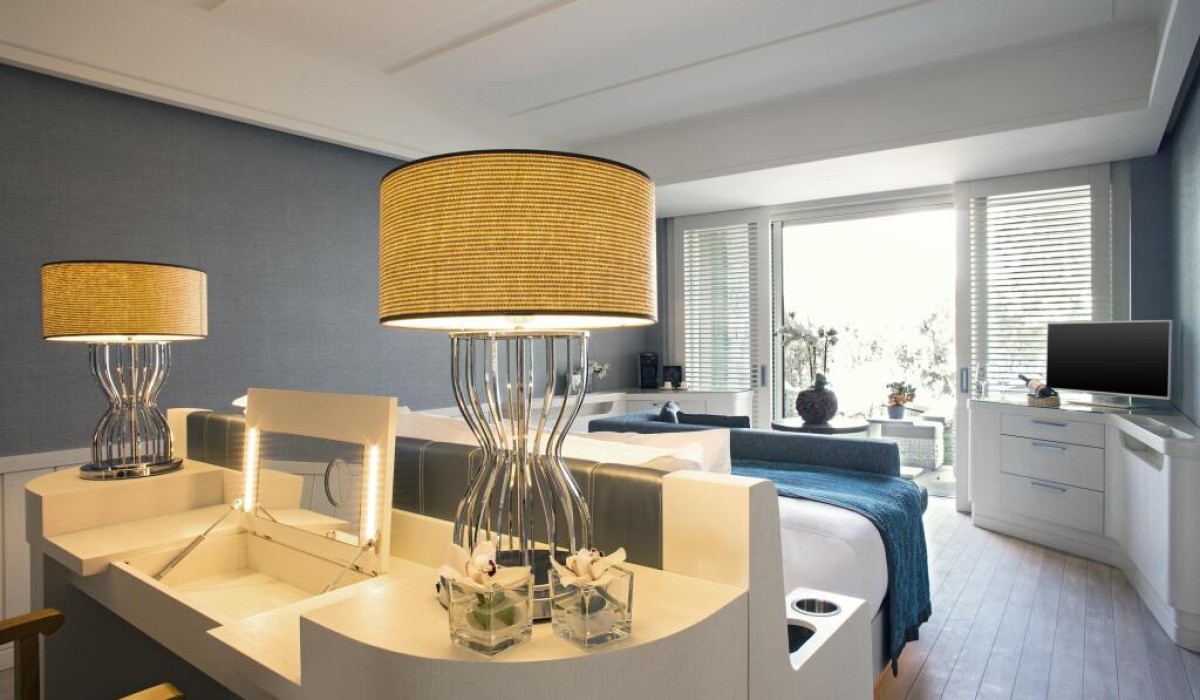 Caresse, a Luxury Collection Resort & Spa, Bodrum - Bright and elegant room with king-size bed, modern furnishings, lounge area, private terrace, and refined details throughout.