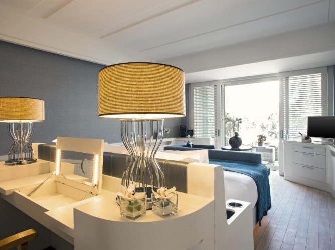 Caresse, a Luxury Collection Resort & Spa, Bodrum - Bright and elegant room with king-size bed, modern furnishings, lounge area, private terrace, and refined details throughout.