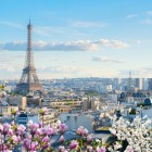 The Eiffel Tower rises gracefully above the Parisian rooftops, dominating the cityscape. A perfect contrast between the city’s iconic symbol and the buildings that tell its history.