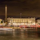 At night, Place de la Concorde glows with golden lights reflecting on the wet pavement, while the obelisk rises at the center, a majestic and silent guardian of the square.