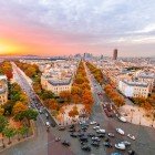 From the Arc de Triomphe you can see La Défense on the horizon, with its skyscrapers and the Grande Arche rising beyond the Champs-Élysées, contrasting with historic Paris.