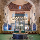 The interiors of the Green Mosque in Bursa are an explosion of art and color, with turquoise and green ceramic tiles, intricate Islamic patterns, and calligraphy that create a sacred and evocative atmosphere.