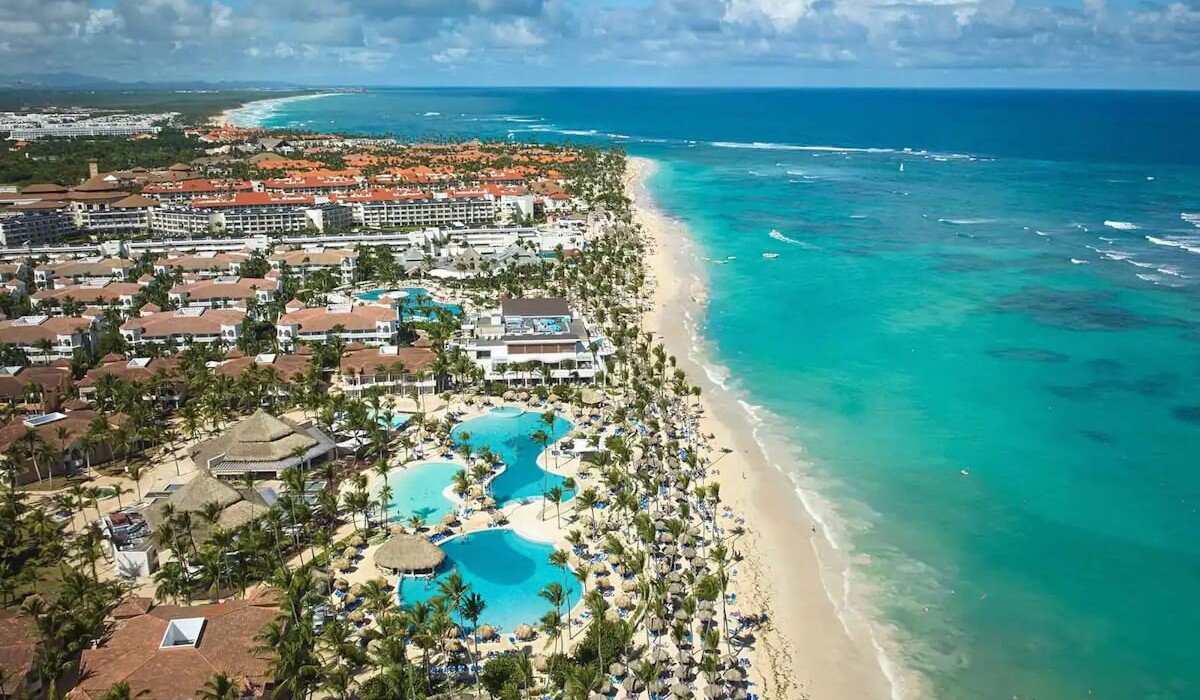 Bahia Principe Grand Punta Cana - All Inclusive - Aerial view of Bahia Principe Grand Punta Cana - All Inclusive with large pools surrounded by tropical greenery and the stunning white-sand beach facing the Caribbean Sea.