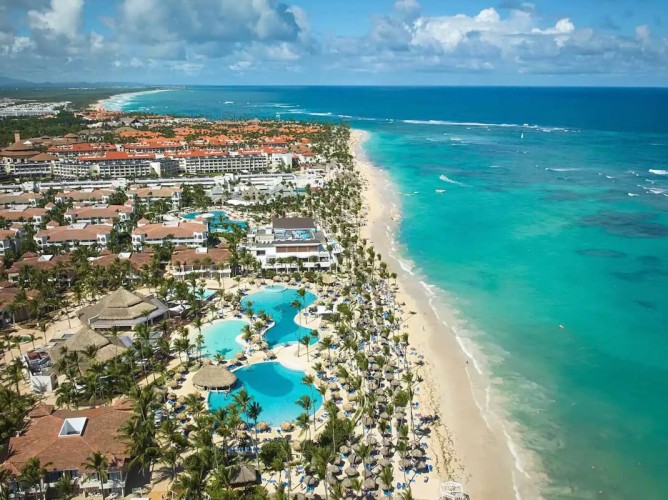 Bahia Principe Grand Punta Cana - All Inclusive - Aerial view of Bahia Principe Grand Punta Cana - All Inclusive with large pools surrounded by tropical greenery and the stunning white-sand beach facing the Caribbean Sea.