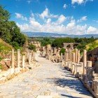Ancient street of Ephesus lined with columns and statues, leading to the Library of Celsus, a symbol of knowledge and the cultural heart of the Roman world.