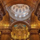 Dome and golden altar of the Church of La Compañía de Jesús in baroque style, a stunning masterpiece of Quito and iconic landmark of Ecuador’s historic center.