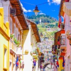 Beautiful colonial buildings with flags on balconies adorn the historic center of Quito, northern Ecuador, offering a glimpse of Andean charm and heritage.