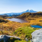The majestic Antisana volcano rises over the Andes with its gleaming glaciers, offering a breathtaking panorama of clear skies and unspoiled landscapes.