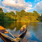 Traditional wooden canoes at sunset on the Napo River, Cotopaxi province, Ecuador, surrounded by the enchanting Amazon rainforest.