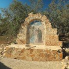 Ancient baptismal font at the Al-Maghtas site, Jordan, the traditional place of Jesus' baptism, surrounded by ruins and historical monuments.