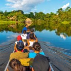 Canoe excursion along the Misahuallí and Napo rivers in the Amazon Basin, inside Yasuni National Park, with a charming view of a lodge in authentic traditional style, Ecuador.