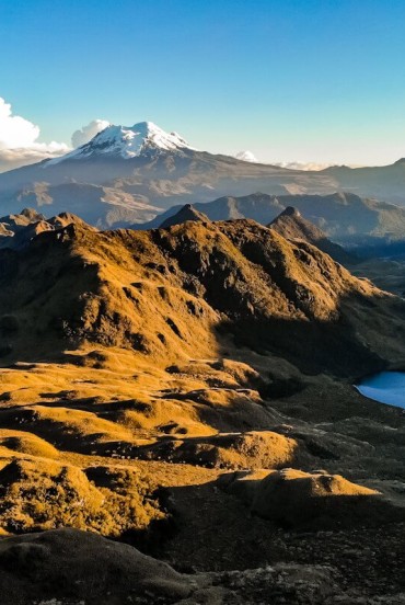 In the Cayambe Coca Reserve, the majestic Antisana volcano rises at twilight, dominating the eastern range of the Ecuadorian Andes with spectacular views.