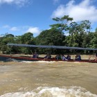A picturesque boat transfer along the Rio Misahuallí, surrounded by Amazonian nature, leads to La Punta pier in the village of Puerto Misahuallí, Ecuador.