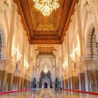 The interiors of the Hassan II Mosque amaze with carved ceilings, colorful mosaics, crystal chandeliers, and luxurious marble floors.