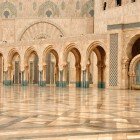 The exterior of the Hassan II Mosque enchants with elegant arches and fountains that reflect Islamic art, creating an atmosphere of peace and grandeur by the sea.