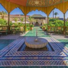 The central fountain of the Secret Garden in Marrakech, connected to the traditional water system, reflects plants and pathways, creating an oasis of serenity.