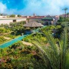 From above, the Secret Garden in Marrakech shows perfect geometries, lush plants, and winding paths among hidden corners and fountains.