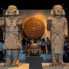 Sculptures of Coatlicue of Coxcatlan and the Young God of Coxcatlan in front of the Aztec Sun Stone at the National Museum of Anthropology.