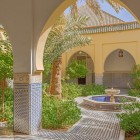The inner courtyard of the Mausoleum of Moulay Ali Cherif features refined architectural details, carved arches, and traditional Moroccan decorations.
