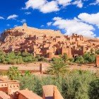 Ait Ben Haddou, a UNESCO World Heritage site, is an ancient red-earth ksar between Ouarzazate and the desert, famous for its kasbahs, winding alleys, and cinematic landscapes.